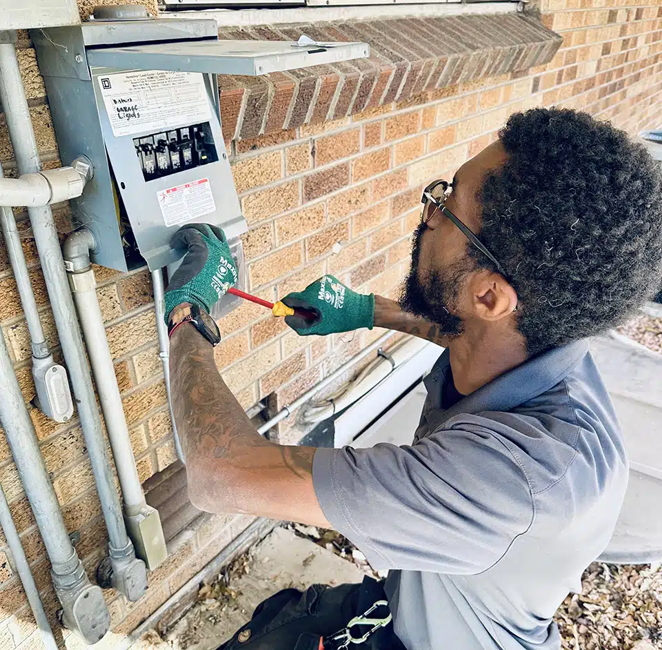 Technician installing breaker box in Denver, CO.