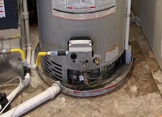 Close-up of Bradford White water heater base with gas line and electronic ignition installed in Denver, CO