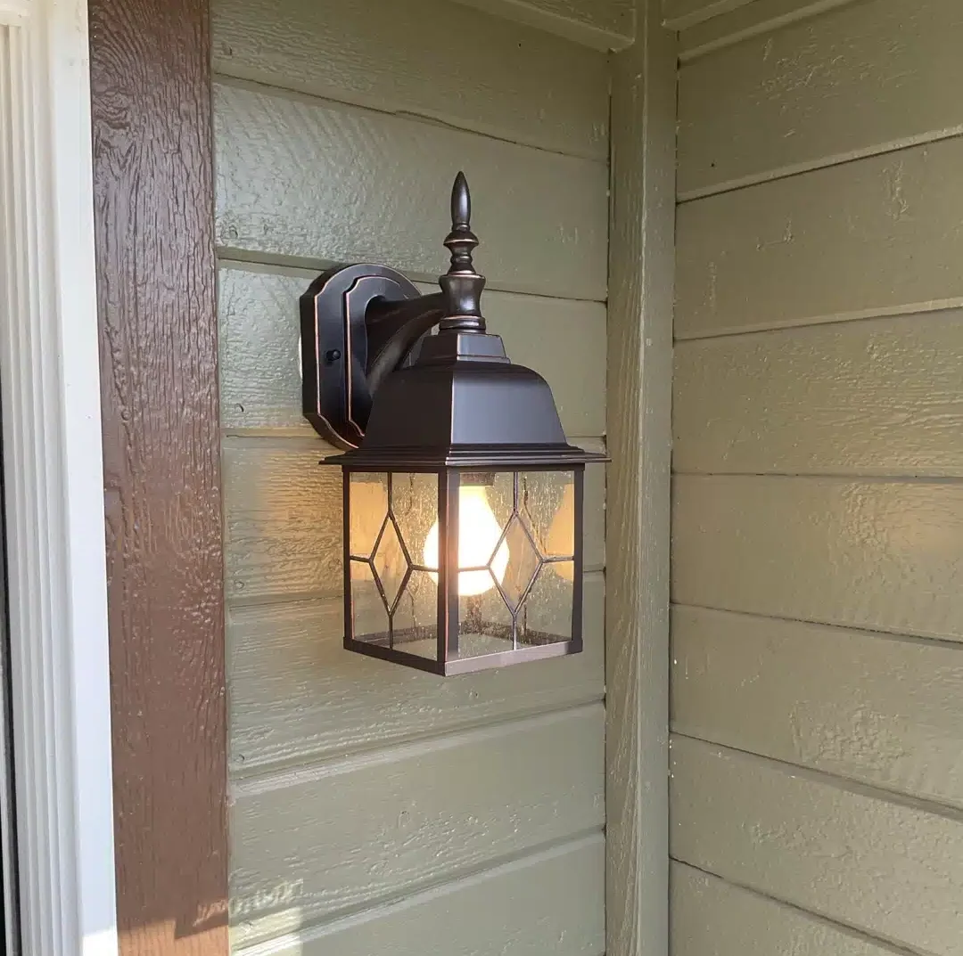 Bronze outdoor lantern sconce installed by Top Shelf Electric on a Denver, CO home exterior