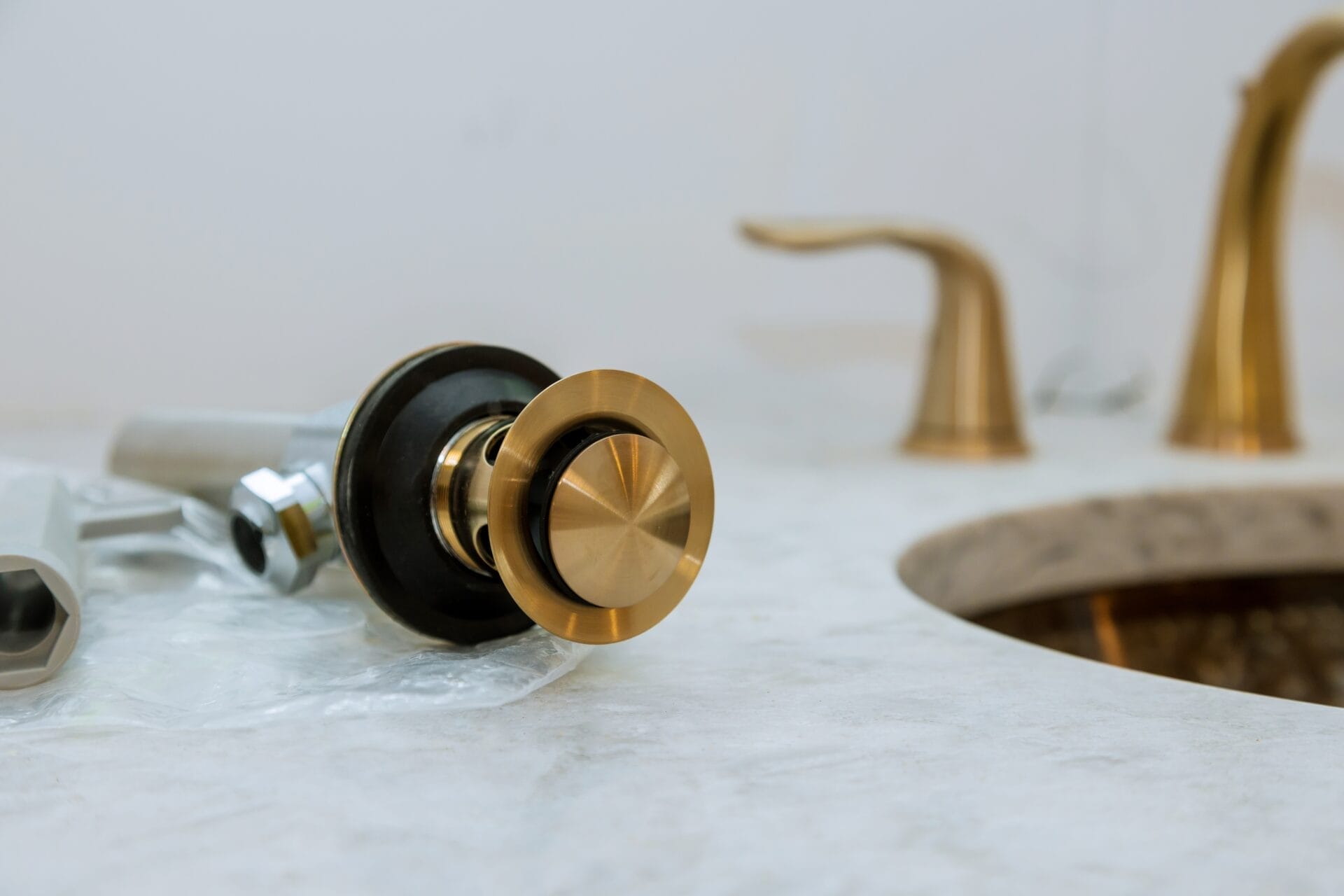 Plumber installs assembly drain a bathroom sink equipment in a bathroom, plumbing repair service