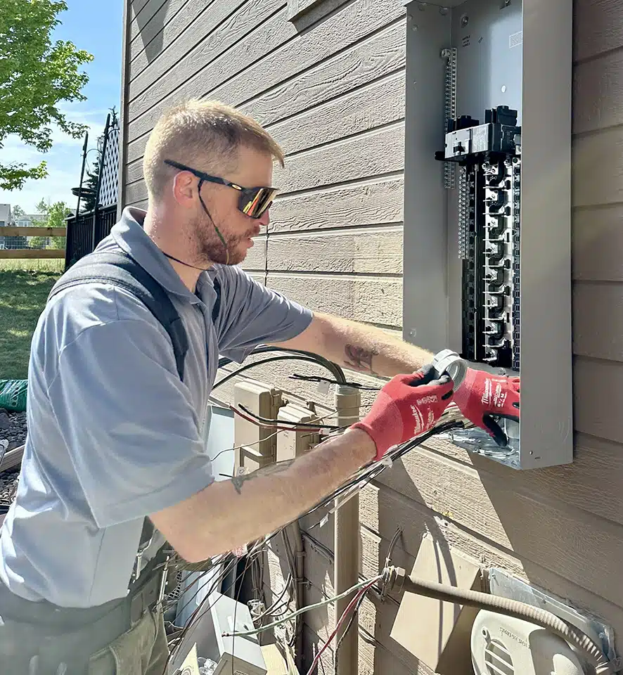 Top Shelf technician servicing electrical panel.