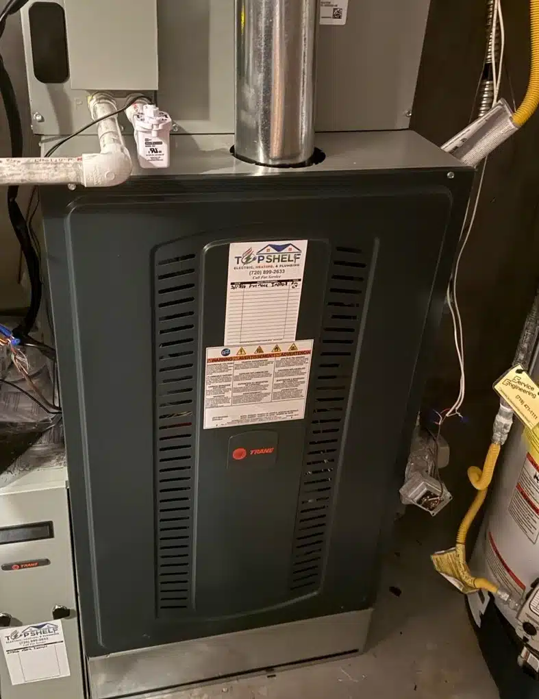 New Trane gas furnace installation with flue pipe in a Denver, CO home mechanical room by Top Shelf