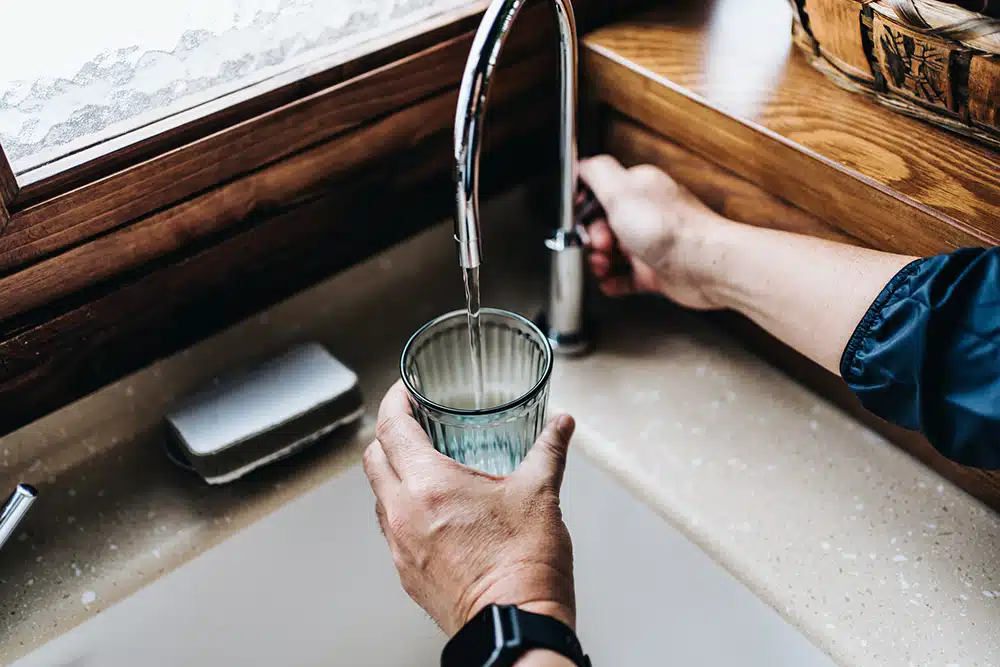 filling up water glass in kitchen sink