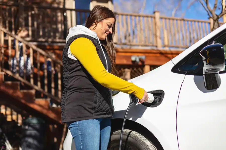 Colorado woman using EV charger to charge electric vehicle
