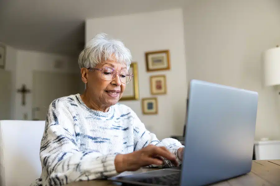 Senior woman using a laptop for financing options